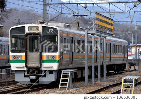 Two Iida Line 213 series 5000 series local trains waiting on the electric storage line 136630393