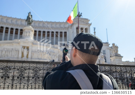 Tourist photographing monument in Rome Italy 136630515