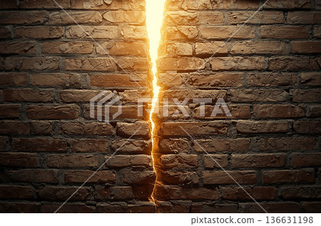 Crack in brick wall with bright light 136631198