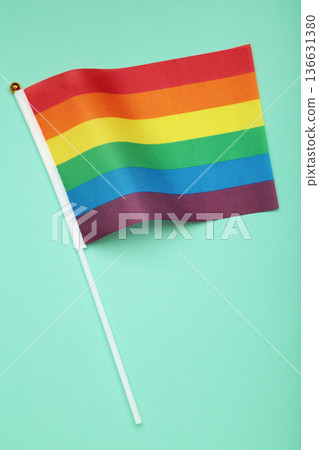 LGBT rainbow flag flat lay on mint background. Human rights, gay marriage, june parade, lgbtq proud history month concept, coming out day. top view, place for logo or text LGBT rainbow flag flat lay on mint background. Human rights, gay marriage, june parade, lgbtq proud history month concept, coming out day. top view, place for logo or text 136631380