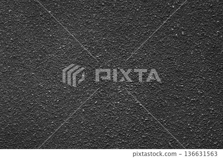 The black cement wall has an uneven surface. The black cement wall has an uneven surface. 136631563