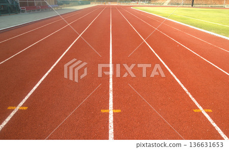 Red running track in stadium. 136631653