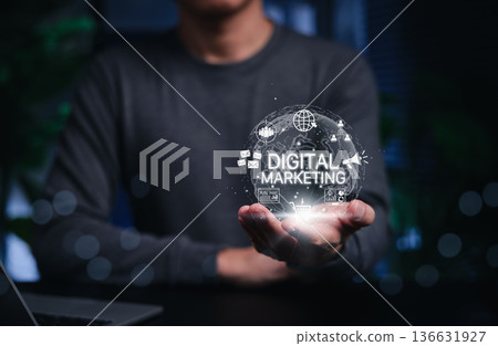 Digital marketing concept. Person holding glowing globe and digital icons like email, shopping cart, ads, analytics, and communication tools. represents online advertising, strategy, and promotion. 136631927