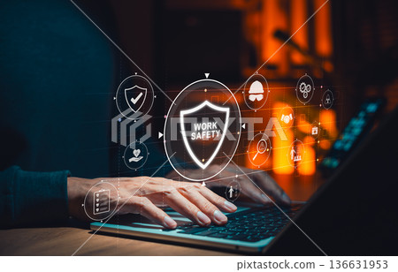 Work safety and occupational health concept. Person using laptop with icons for protection, risk management, assessment and safety protocols compliance in modern workplace and industrial environments. Work safety and occupational health concept. Person using laptop with icons for protection, risk management, assessment and safety protocols compliance in modern workplace and industrial environments. 136631953