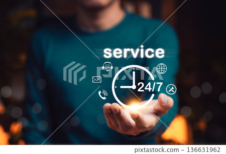 24/7 customer service and support concept. Person holding icon of clock with communication symbols, representing round the clock assistance, global 24 hour service availability and client satisfaction 136631962