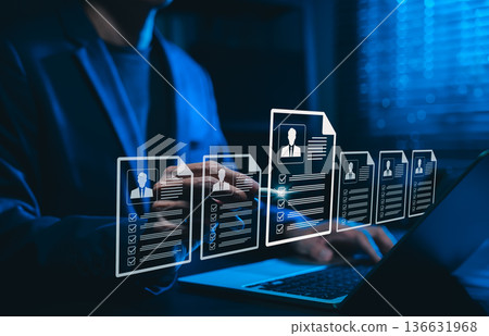 Human resource and recruitment technology concept. Professional selecting resumes with candidate profiles, symbolizing AI-powered hiring, digital CV screening and modern talent acquisition strategies. 136631968