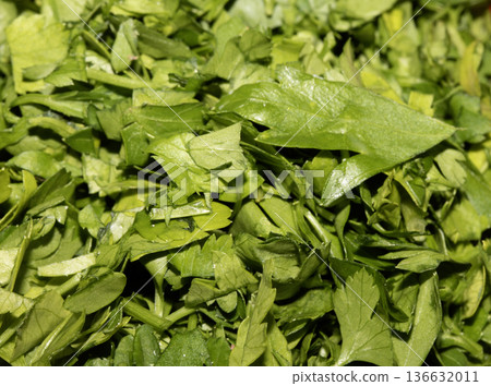 Close up of chopped fresh green herbs basil coriander parsley Close up of chopped fresh green herbs basil coriander parsley 136632011