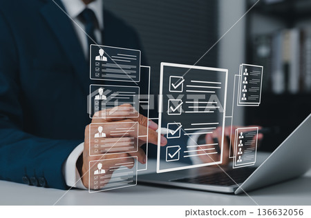 Recruitment process concept, HR manager analyzing digital candidate profiles and checklists on virtual interface, selecting qualified applicants for job positions using modern hiring technology. 136632056