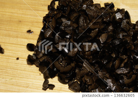 Thinly sliced chopped black olives close up vegetables Thinly sliced chopped black olives close up vegetables 136632605