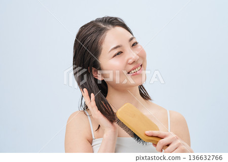 年輕女子用梳子梳頭 年輕女子用梳子梳頭 136632766