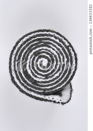 Rolled Striped Knit Scarf on White Background 136633382