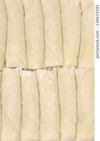 Row of frozen spring rolls Row of frozen spring rolls 136633395