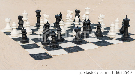 Strategic game of chess. Chessboard. Strategic and tactic. Chess pieces on the chessboard outdoor. Playing chess. Improve tactic and logic Strategic game of chess. Chessboard. Strategic and tactic. Chess pieces on the chessboard outdoor. Playing chess. Improve tactic and logic 136633549