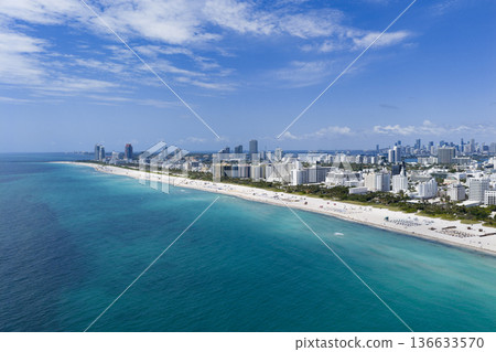 Miami beach with turquoise waters. Aerial view of sandy coastline and waves. 136633570