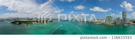 Panorama of Miami Beach with turquoise waters. Drone shot of Miami skyline. Top view of South Beach. Miami cityscape with luxury skyscrapers and ocean. View of Miami famous coastline. Panorama of Miami Beach with turquoise waters. Drone shot of Miami skyline. Top view of South Beach. Miami cityscape with luxury skyscrapers and ocean. View of Miami famous coastline. 136633583