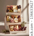 Exquisite boxes with meat snacks, cheese, nuts and fruits. Exquisite snack boxes are filled with delicacies. 136633627