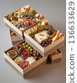 Exquisite boxes with meat snacks, cheese, nuts and fruits. Exquisite snack boxes are filled with delicacies. 136633629