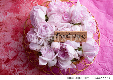 roses bouquet against double pink color background with "best wishes". romantic concept roses bouquet against double pink color background with "best wishes". romantic concept 136633675