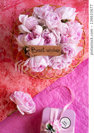 roses bouquet against double pink color background with "best wishes" words. romantic and beauty concept roses bouquet against double pink color background with "best wishes" words. romantic and beauty concept 136633677