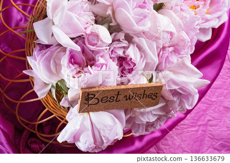 roses bouquet against pink color background with "best wishes" words. romantic and beauty concept roses bouquet against pink color background with "best wishes" words. romantic and beauty concept 136633679