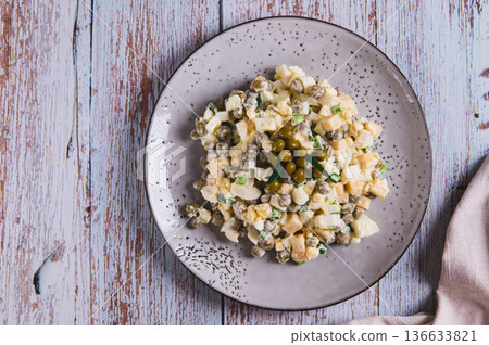 Close up of protein salad with eggs, cheese, green peas and onions on a plate top view 136633821