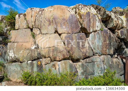 Petroglyphs at Kalbak-Tash rock art complex Altai Russia. Ancient carvings showcasing prehistoric cultural heritage. 136634300