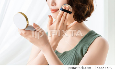 Woman applying makeup/beauty image Woman applying makeup/beauty image 136634389