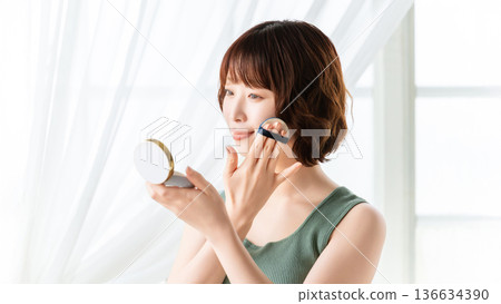 Woman applying makeup/beauty image 136634390