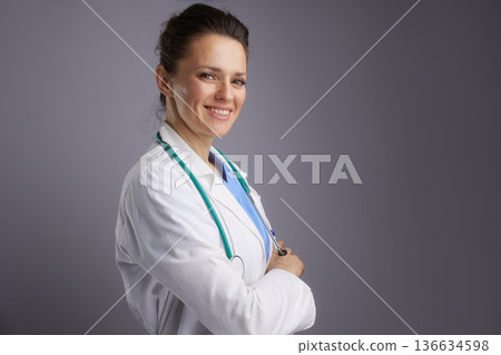 Friendly Female Doctor Posing with Crossed Arms 136634598
