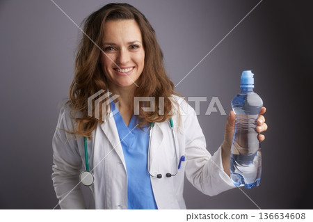 Doctor Holding Water Bottle for Wellness Campaign 136634608