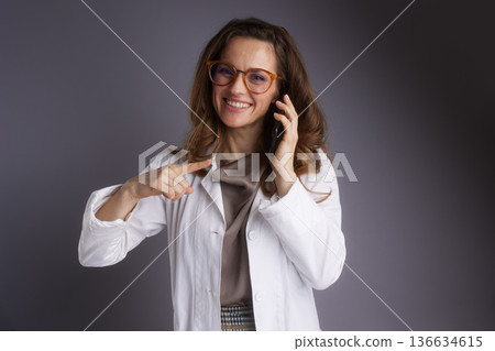 Professional Female Doctor Pointing and Calling Professional Female Doctor Pointing and Calling 136634615