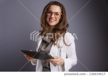 Professional Doctor with Tablet and Friendly Smile 136634617