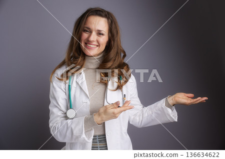 Female Doctor Gesturing with Open Palm for Presentation Female Doctor Gesturing with Open Palm for Presentation 136634622