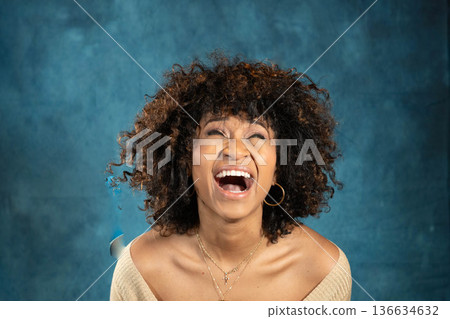 Woman laughing blue background 136634632
