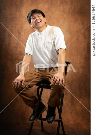 Young man laughing pose Young man laughing pose 136634644