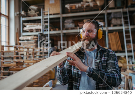 Carpenter preparing the wood pieces before making the furniture. 136634840