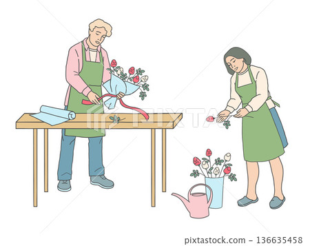 Male florist tying ribbon around bouquet at table and female florist holding rose Male florist tying ribbon around bouquet at table and female florist holding rose 136635458