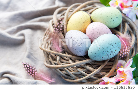 Pastel easter eggs in rustic wicker nest Pastel easter eggs in rustic wicker nest 136635650