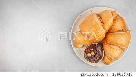 Croissants with chocolate spread on plate top view copy space 136635715