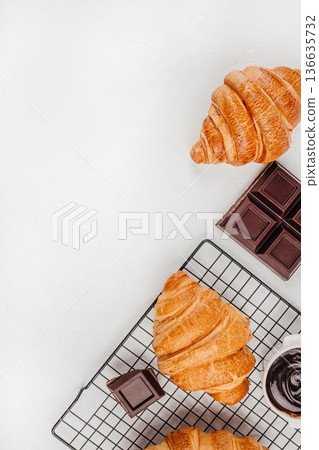 Croissant and chocolate flat lay on white banner background Croissant and chocolate flat lay on white banner background 136635732