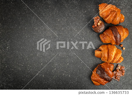 Chocolate croissants arrangement on dark stone background banner 136635733