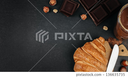Chocolate croissant banner with dark copy space Chocolate croissant banner with dark copy space 136635735