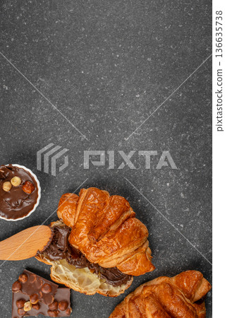 Top view croissant with chocolate hazelnut spread and copy space 136635738