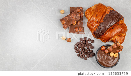 Chocolate croissant with hazelnut spread and chocolate chips banner Chocolate croissant with hazelnut spread and chocolate chips banner 136635739