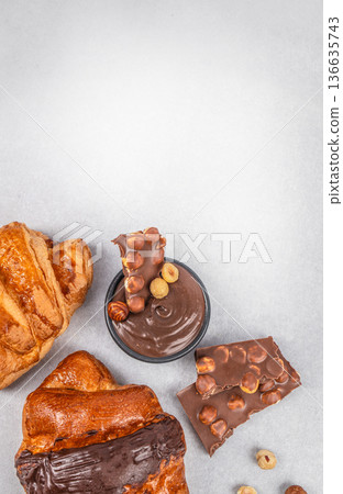 Croissants with hazelnut chocolate spread and nut chocolate pieces banner Croissants with hazelnut chocolate spread and nut chocolate pieces banner 136635743