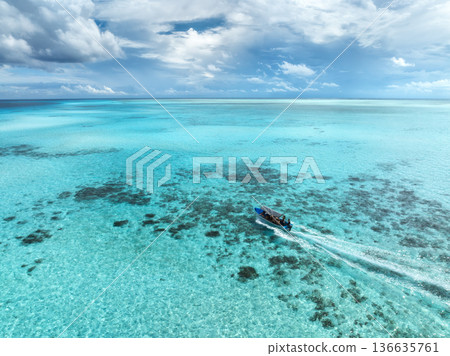 Aerial view of a boat in turquoise sea with transparent water 136635761