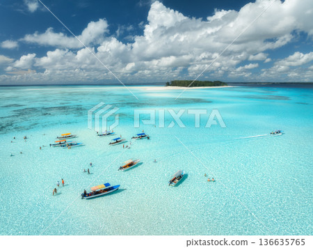 Aerial view of boats in turquoise sea, blue sky with clouds Aerial view of boats in turquoise sea, blue sky with clouds 136635765