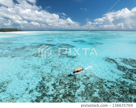 Aerial view of a boat in turquoise sea with transparent water 136635769
