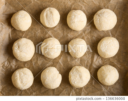 Raw Dough Balls Arranged on Baking Parchment 136636008