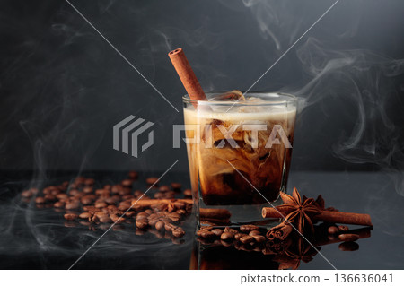 Cold steaming cocktail of cream and coffee on a black background. Cold steaming cocktail of cream and coffee on a black background. 136636041